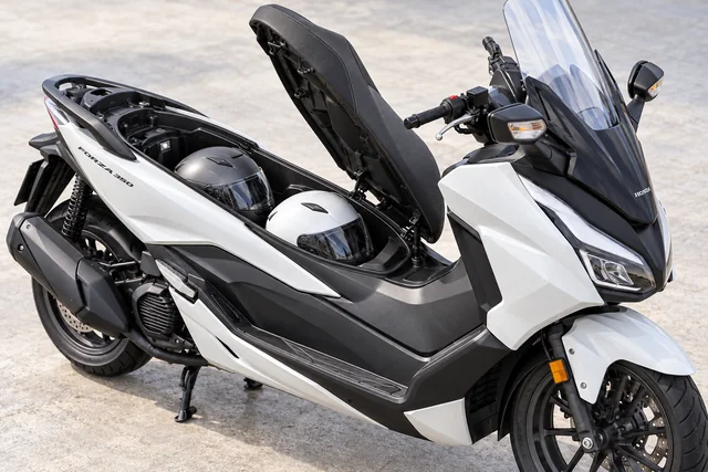 Honda Forza 350 with two helmets under the seat